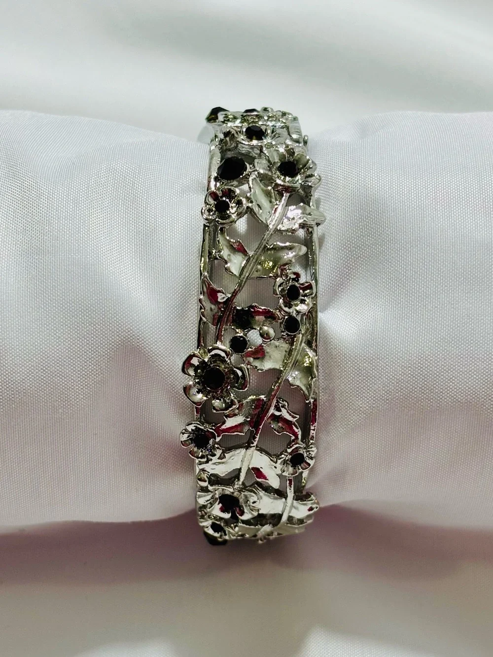 Silver tone Floral Cutout Bangle Bracelet with Deep Garnet Colored Stones 2.5”